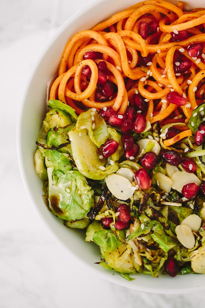 Brussels Sprouts and Sweet Potato Noodle Bowl with Pomegranates and Maple-Sesame Vinaigrette