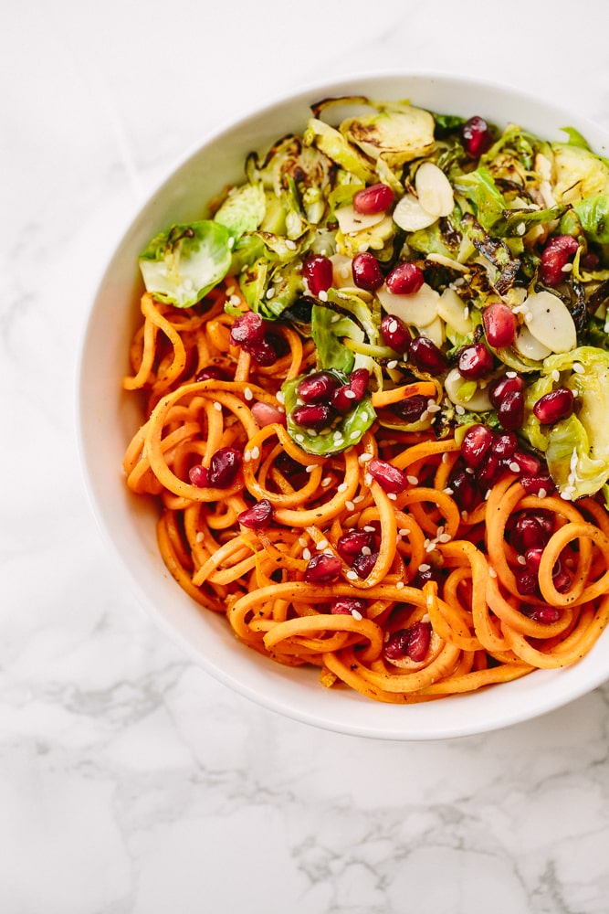 Brussels Sprouts and Sweet Potato Noodle Bowl with Pomegranates and Maple-Sesame Vinaigrette