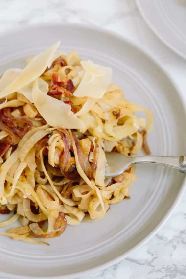 Caramelized Onion and Bacon Kohlrabi Spaghetti with Shaved Parmesan