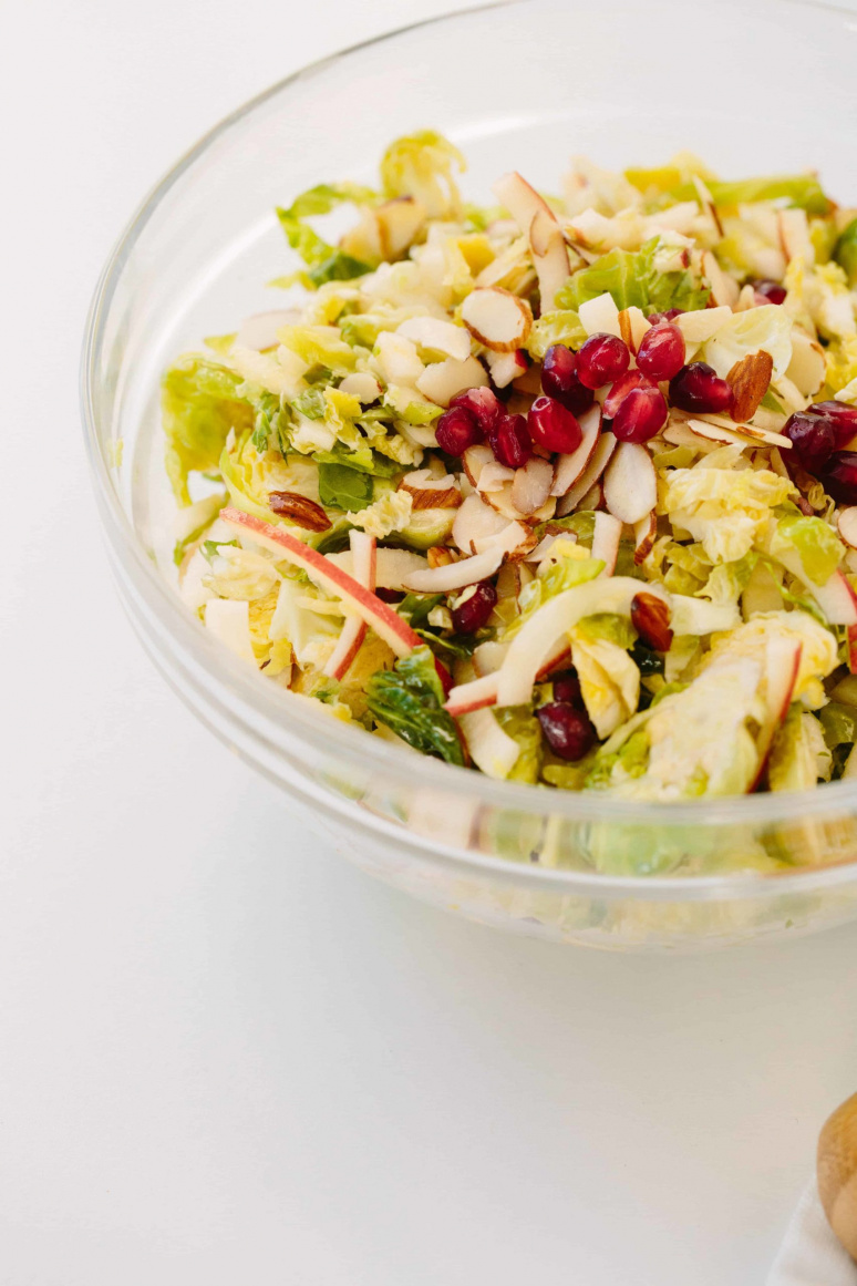 Shredded Brussels Sprouts and Spiralized Apple Slaw with Maple-Cider Dressing and Pomegranates