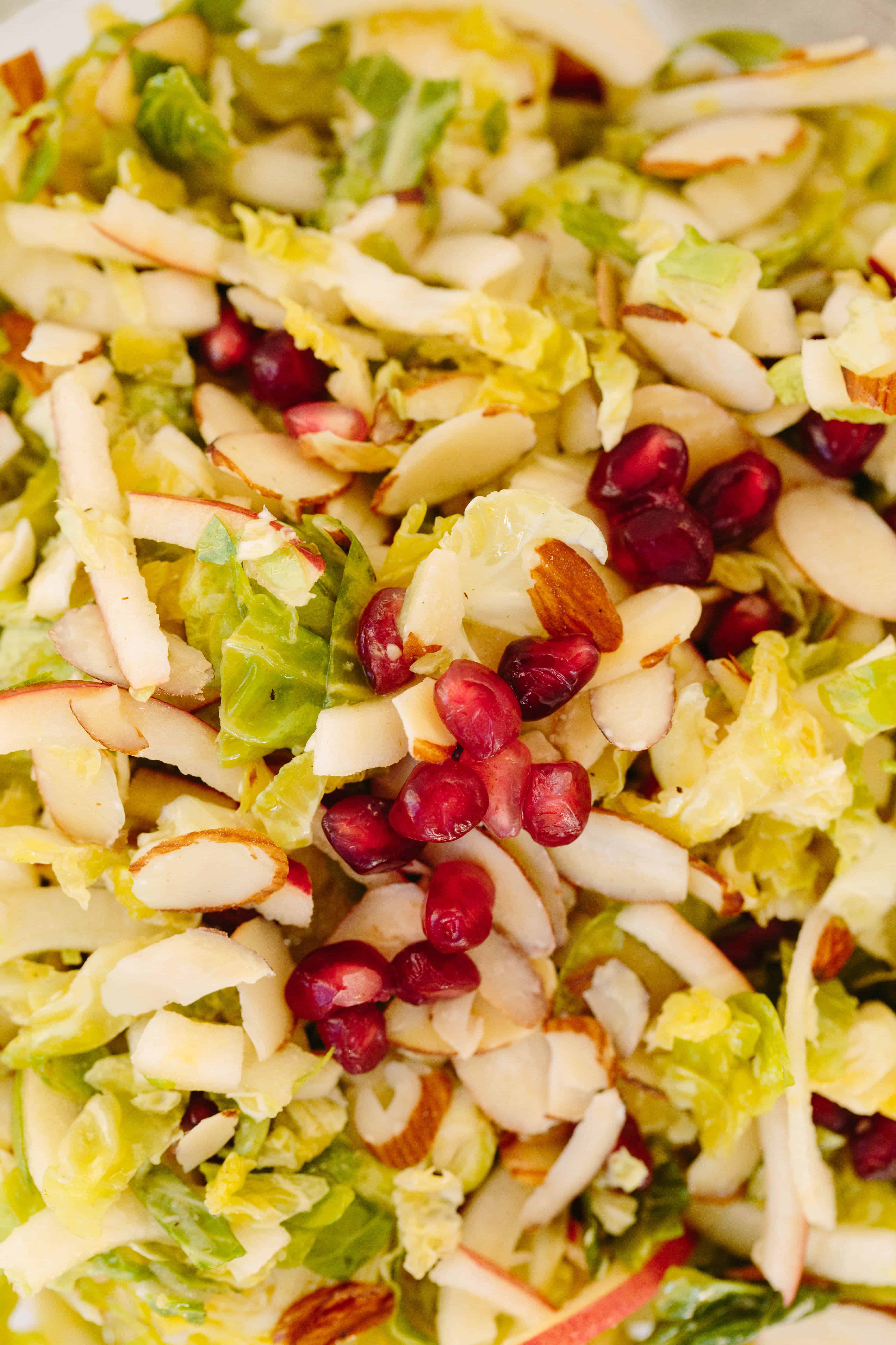 Shredded Brussels Sprouts and Spiralized Apple Slaw with Maple-Cider Dressing and Pomegranates