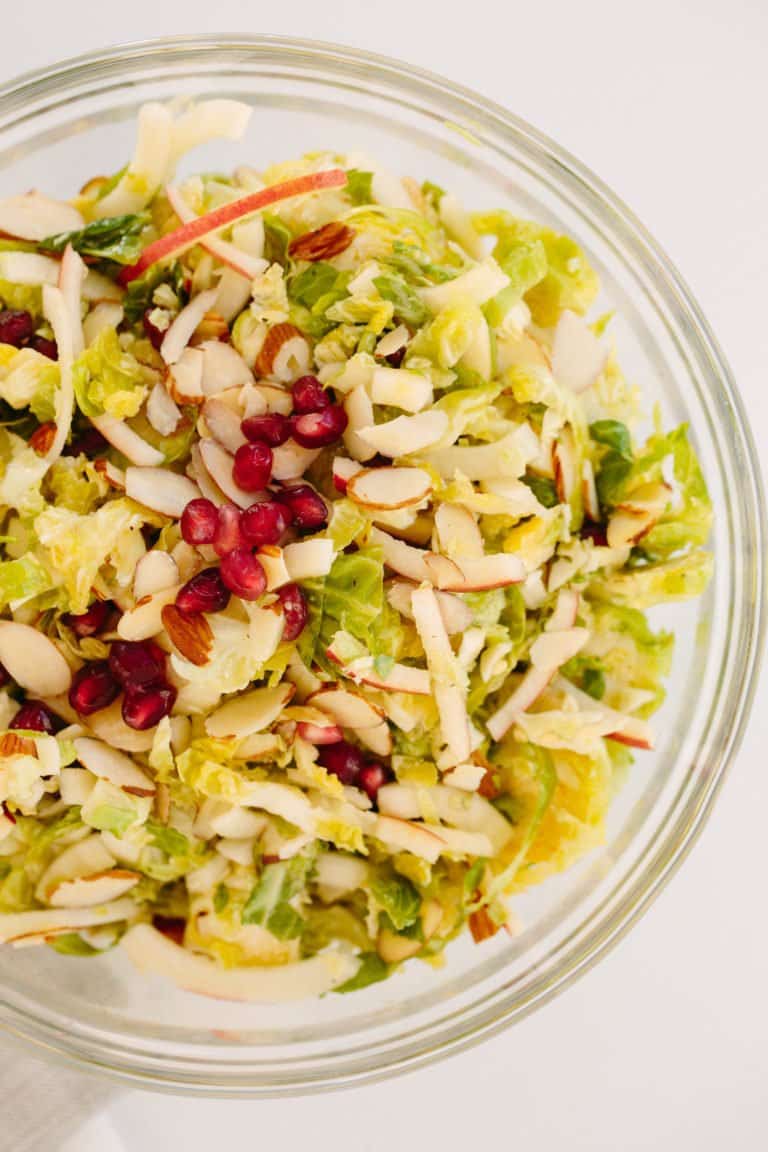  SHREDDED BRUSSELS SPROUTS AND SPIRALIZED APPLE SLAW WITH MAPLE-CIDER DRESSING AND POMEGRANATES