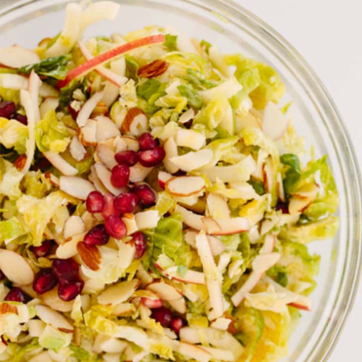 Shredded Brussels Sprouts and Spiralized Apple Slaw with Maple-Cider Dressing and Pomegranates 