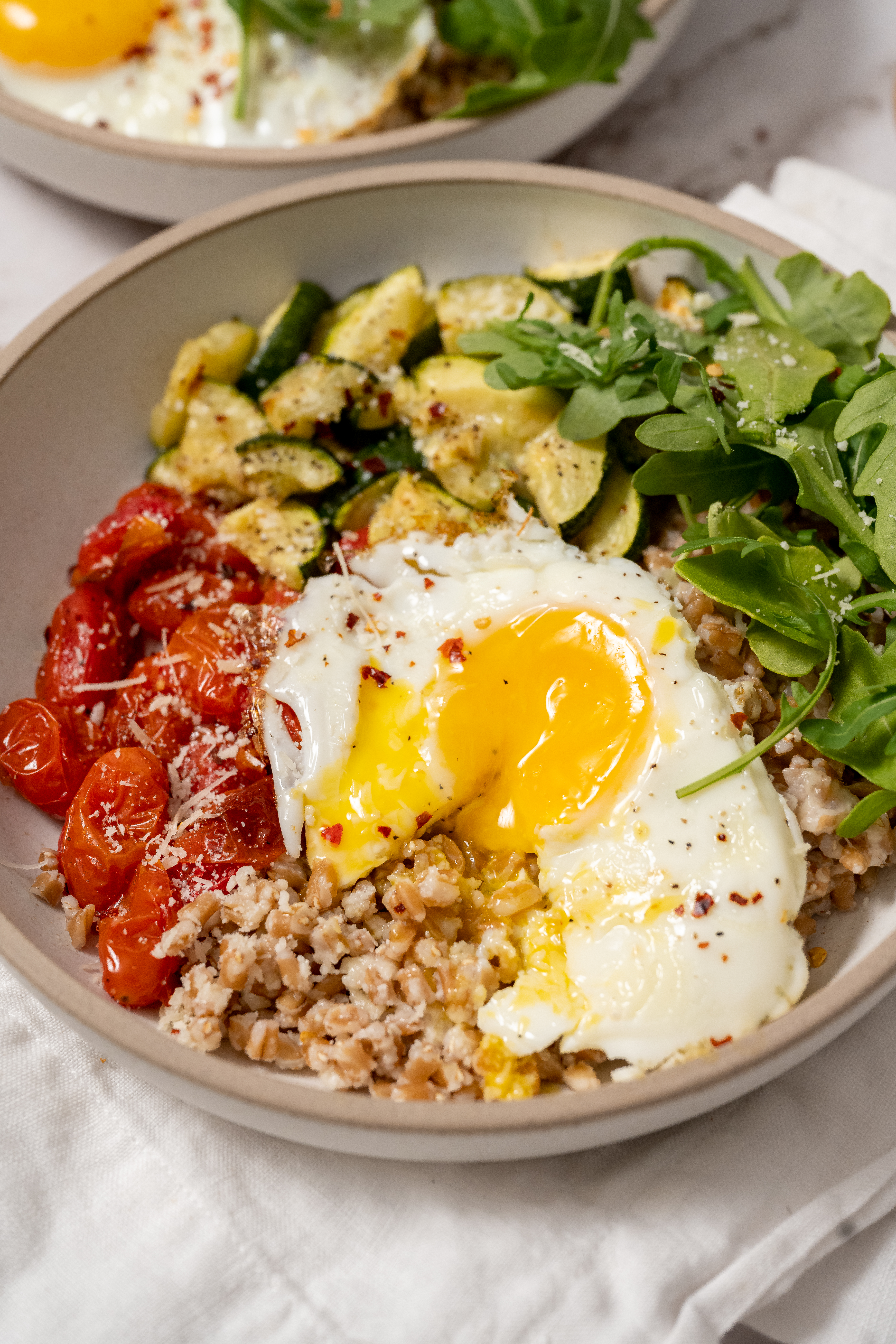 Parmesan Farro and Roasted Zucchini Bowls with Burst Tomatoes and Arugula